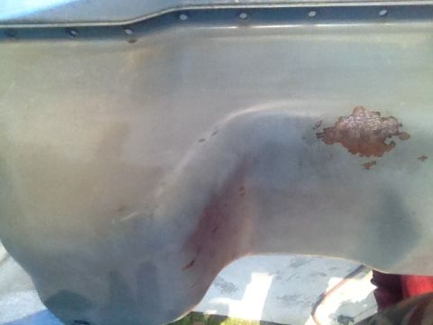 1992 Ford Bronco - Close-up of an oil pan, showing signs of wear and rust.