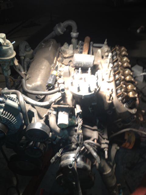 1992 Ford Bronco - Close-up view of an engine assembly, likely undergoing maintenance or rebuild.