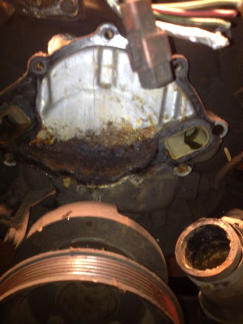 1992 Ford Bronco - Close-up of a corroded engine water pump housing, showing signs of wear and potential leaks.