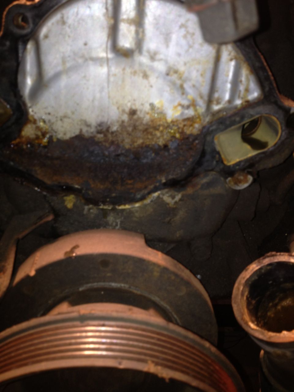 Corroded engine water pump with pulley visible below