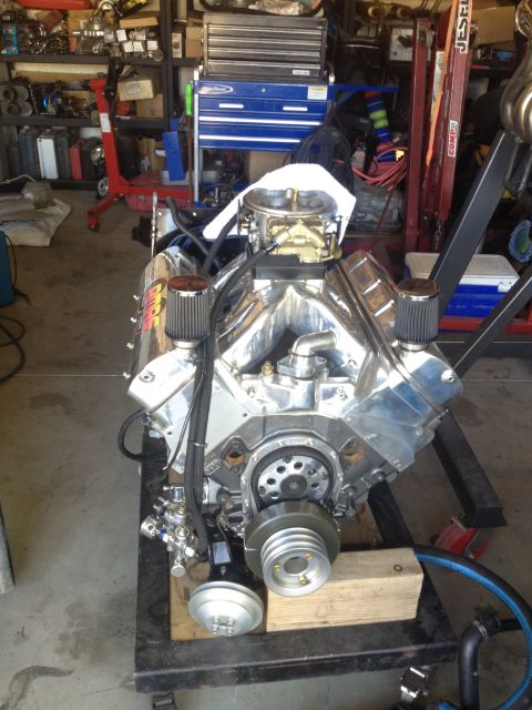 1992 Ford Bronco - A polished V8 engine sits on a stand in a garage, ready for installation or rebuild.