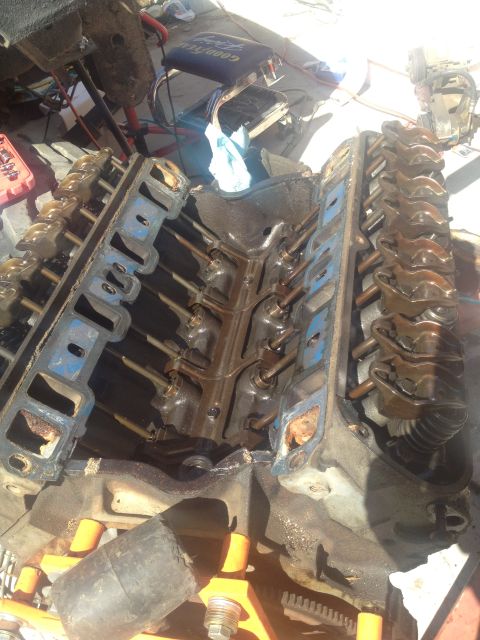 1992 Ford Bronco - Close-up view of an engine block with its valve covers removed, revealing the internal mechanics during a rebuild.