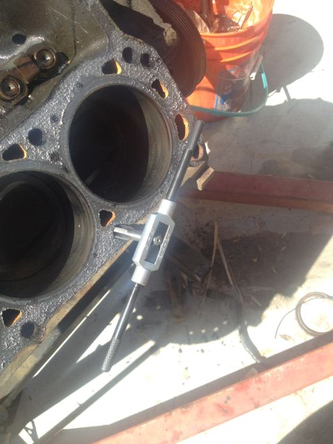 1992 Ford Bronco - A tap tool is used to re-thread a bolt hole on an engine block during a motor rebuild.