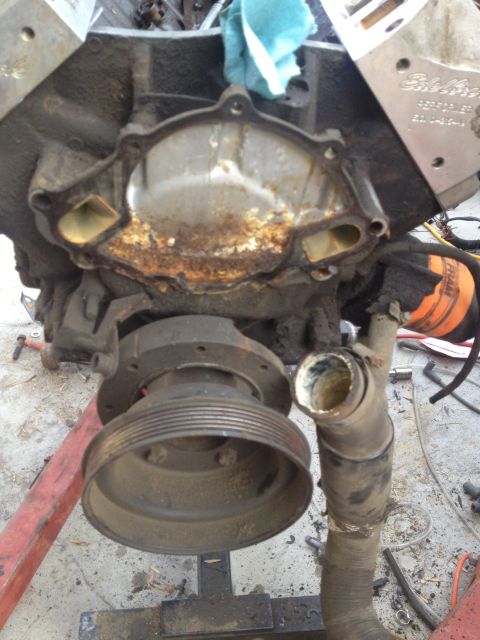 1992 Ford Bronco - The engine block is exposed with the water pump assembly removed, revealing internal wear and corrosion.