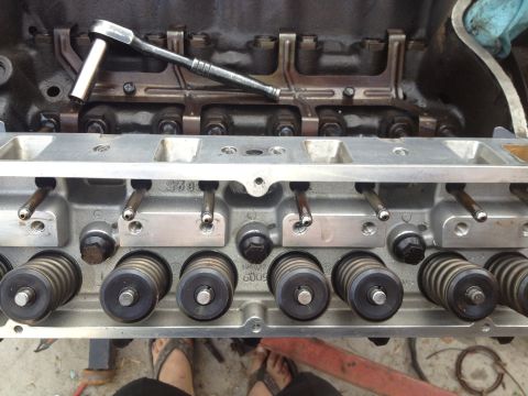 1992 Ford Bronco - Close-up view of an engine's cylinder head during a rebuild, with tools and internal parts visible.