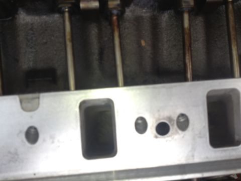 1992 Ford Bronco - Close-up view of engine cylinder head ports and pushrods, likely during a rebuild.