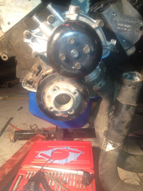 1992 Ford Bronco - Close-up of an engine water pump and pulley assembly, likely during a rebuild or repair.