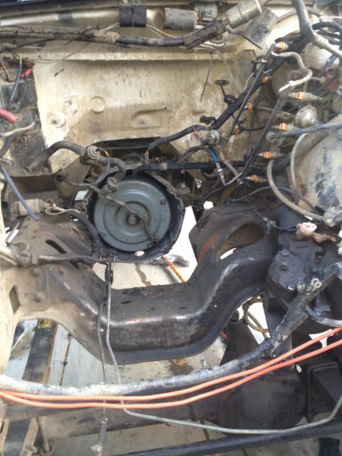1992 Ford Bronco - This image shows the engine bay of a vehicle during a motor rebuild, with the transmission and frame components clearly visible.