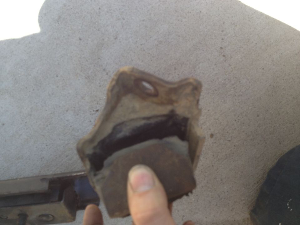 Worn engine mount with rubber torn from metal bracket