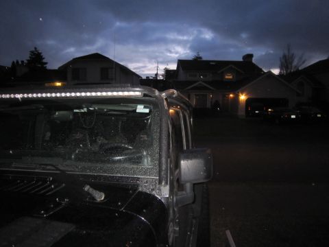 2008 Jeep Wrangler - A black Jeep Wrangler is parked in a driveway at dusk, with houses in the background.