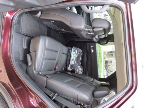 2012 Dodge Durango - Rear interior view of a 2012 Dodge Durango, equipped with leather seats and a child car seat.