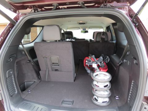 2012 Dodge Durango - The cargo area of the SUV contains a golf bag and stroller wheels, with the rear seats folded down.