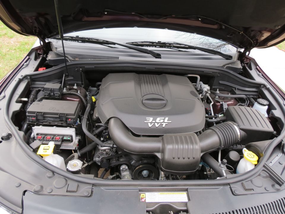 Engine bay with 3.6L VVT engine cover. Fuse box and air intake visible
