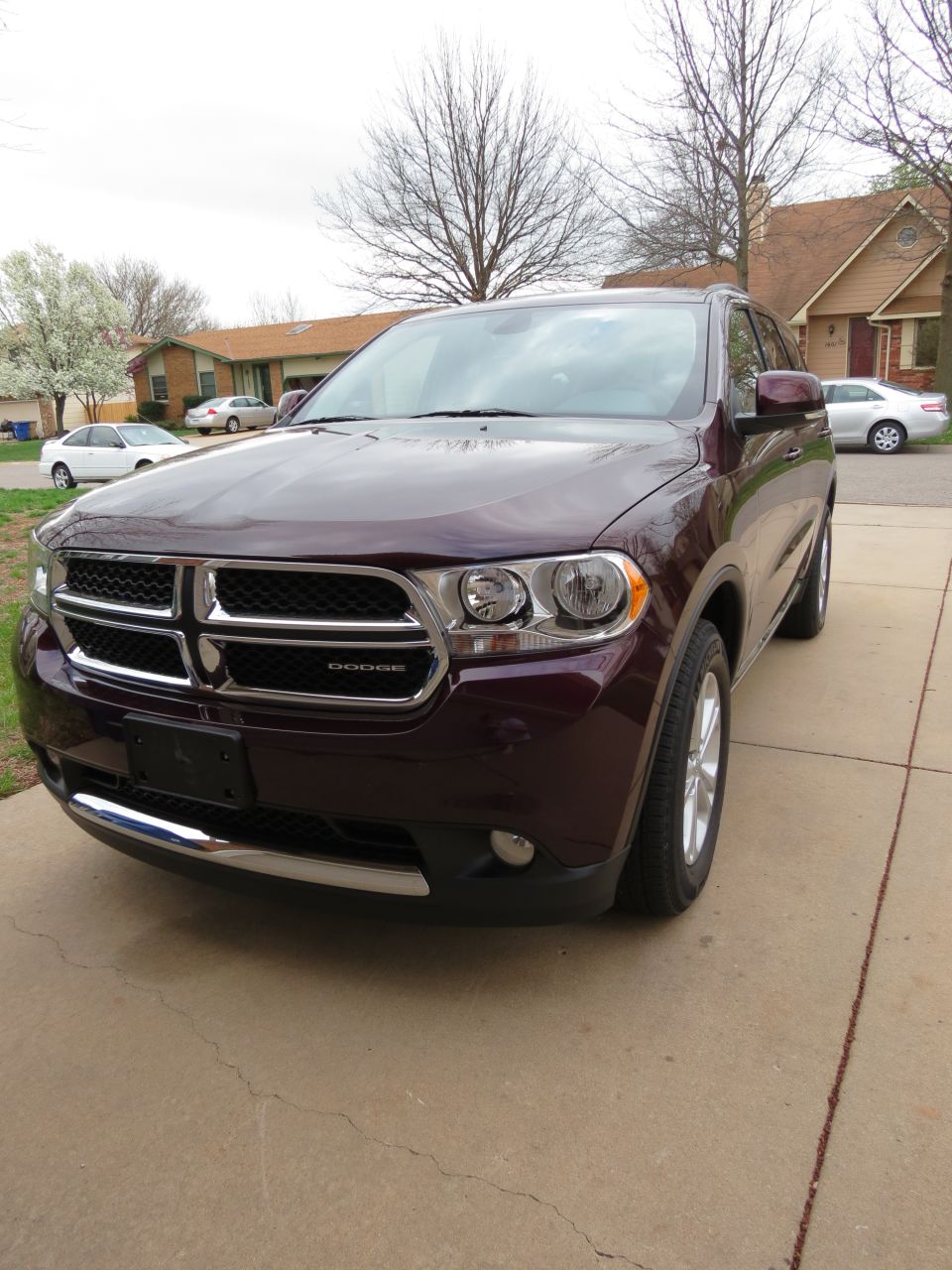 Dark red Dodge Durango SUV parked in a driveway, front 3/4 view