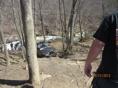 1979 Ford Bronco - Off-road Jeep Wrangler on a challenging trail beside a river, captured on March 17, 2012.