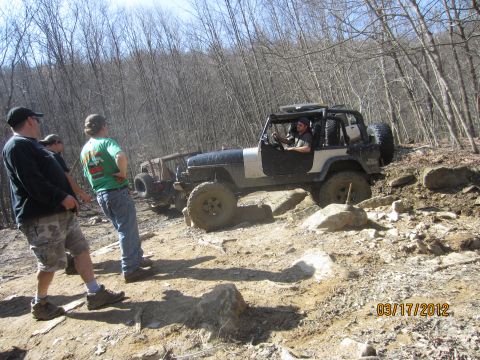 1979 Ford Bronco - Off-road enthusiasts tackle a challenging rocky course with their modified Jeeps.
