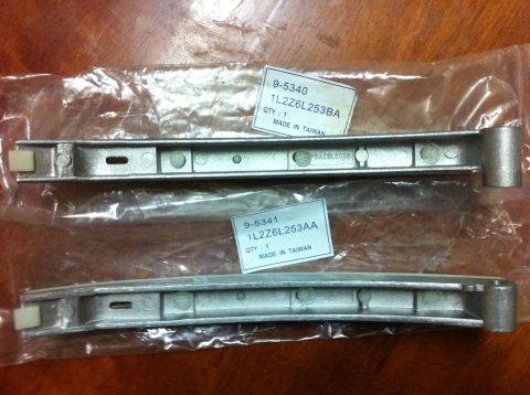1998 Ford Crown Victoria - New timing chain guides, part numbers 1L2Z6L253BA and 1L2Z6L253AA, are shown in their original packaging.