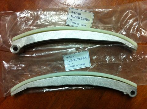 1998 Ford Crown Victoria - These are new timing chain guides, packaged for sale. The labels indicate specific part numbers for identification.