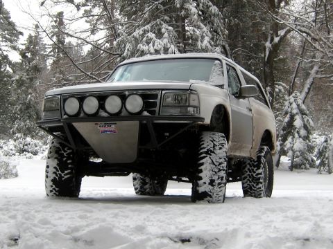 1996 Ford Bronco - Modified 1996 Ford Bronco sits in a snowy landscape with trees in the background.