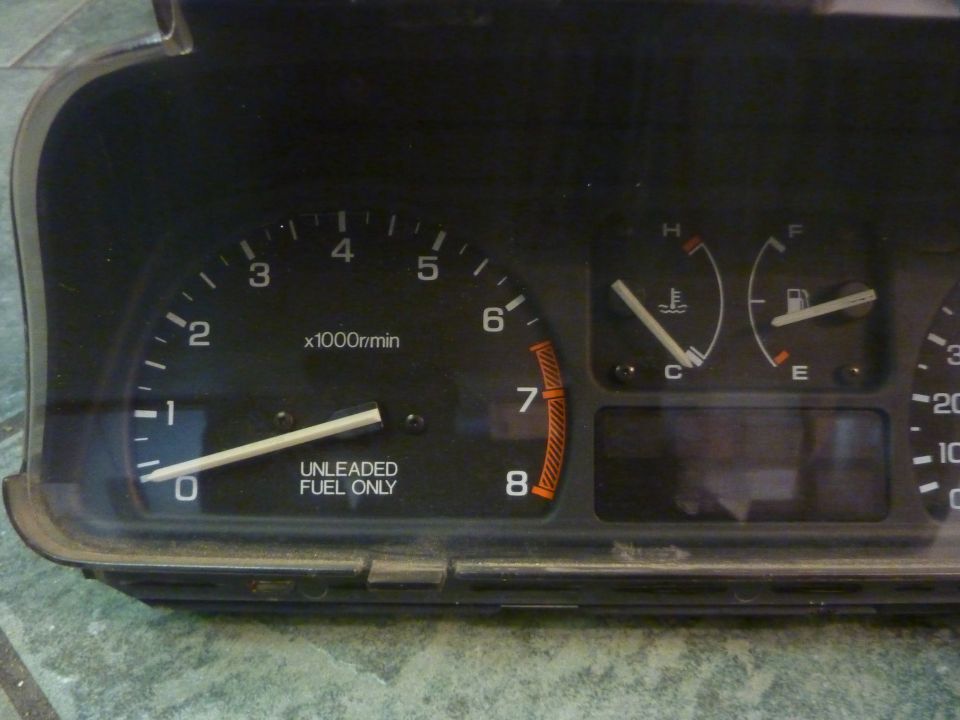 Dashboard gauge cluster with tachometer, fuel, and temperature gauges