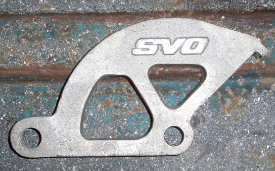 Metal bracket with SVO logo, on a rusty surface