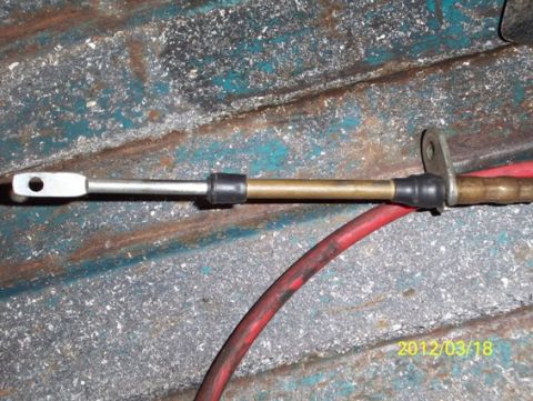 1968 Ford Ranchero - Close-up of a control cable and a red hose against a textured background, with a date stamp and website visible.