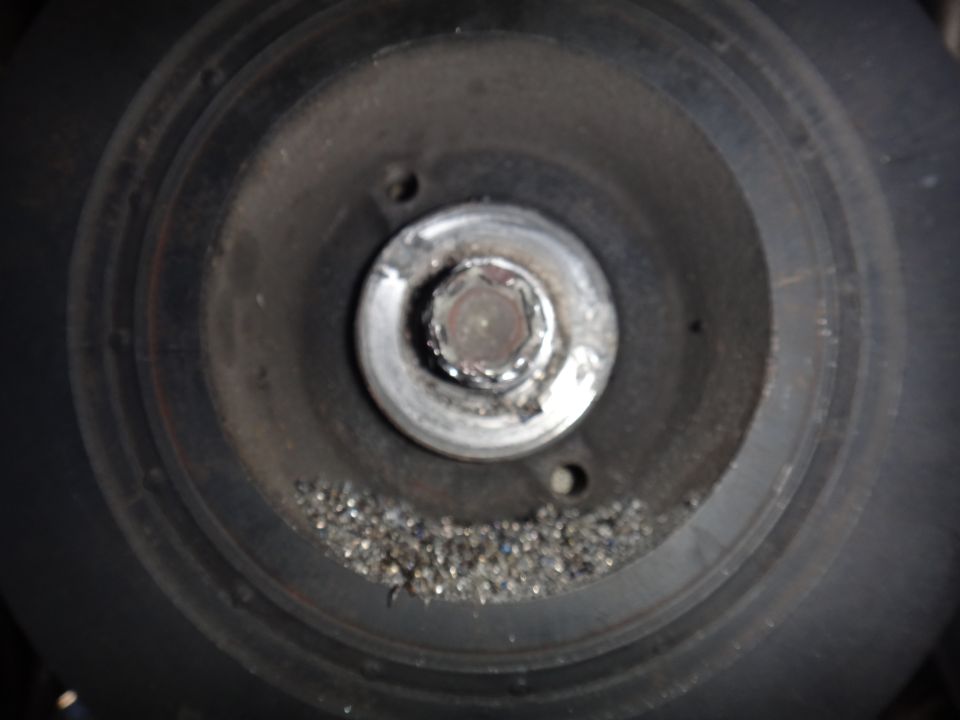Pulley with metal shavings around the center bolt
