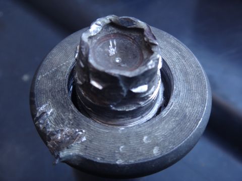 1993 Ford Taurus - Close-up of a damaged bolt head, likely from a vehicle component.