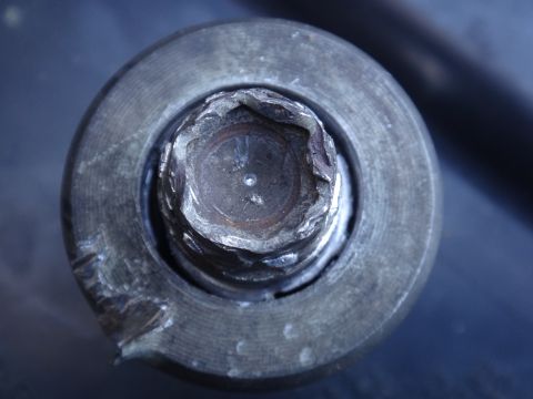1993 Ford Taurus - The hex bolt head shows significant wear and damage, indicating it may be difficult to remove.