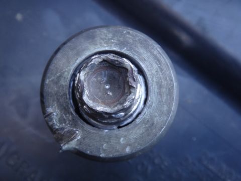 1993 Ford Taurus - A close-up of a damaged hex bolt head, showing significant wear and tear on its hexagonal socket.