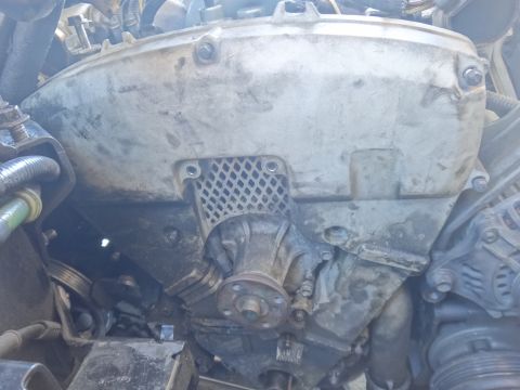 1993 Ford Taurus - The engine's water pump and timing cover are visible in this close-up shot.