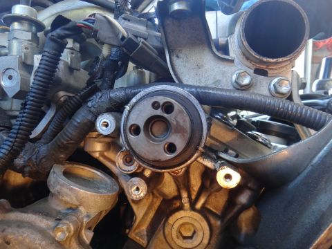 1993 Ford Taurus - Close-up view of engine components, focusing on the oil filter housing and associated plumbing.