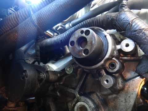1993 Ford Taurus - Close-up view of an engine component with hoses and metal parts.