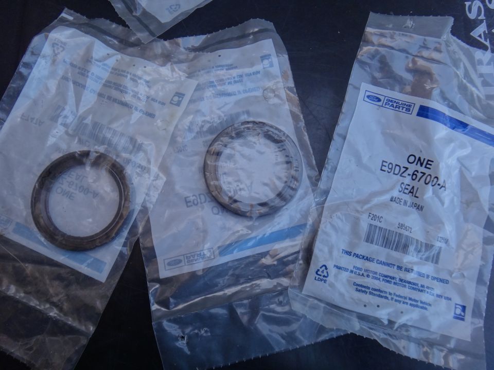 Three sealed Ford parts, one labeled E9DZ-6700-A SEAL