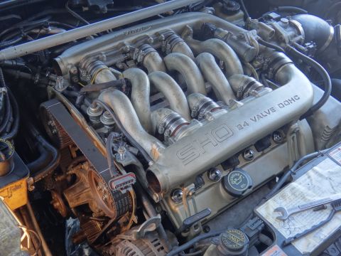 1993 Ford Taurus - Close-up of an engine bay, the "SHO 3.4 VALVE DOHC" inscription on the intake manifold.