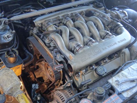 1993 Ford Taurus - Close-up of a V6 engine, showing the intake manifold with 'SHO 3.0L 24 VALVE DOHC' markings.