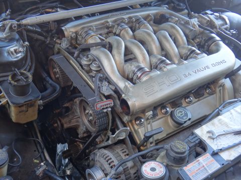 1993 Ford Taurus - The engine bay shows a SHO 3.0L V6 engine, identified by the 'SHO 24 VALVE DOHC' inscription.
