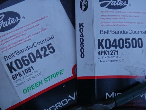 1993 Ford Taurus - Two boxes of Gates belts are shown, with part numbers K060425 and K040500 clearly visible.
