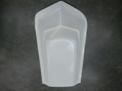 1976 Chevrolet Corvette - This is a white plastic part, possibly a car interior component, against a dark background.