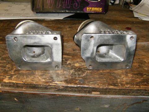 2000 Ford E350 - Two intake manifold parts are shown on a wooden surface, with a box labeled 'VFORCE' in the background. The registry claim of a 2000 Ford E…