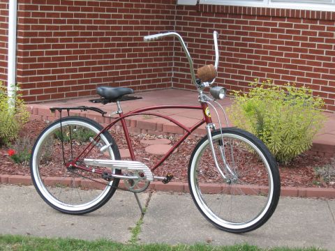 1994 Ford Bronco - A classic cruiser bicycle is parked on a sidewalk in front of a brick house.