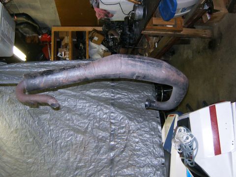 2000 Ford E350 - An exhaust pipe is shown laid out on a tarp in what appears to be a garage or workshop.