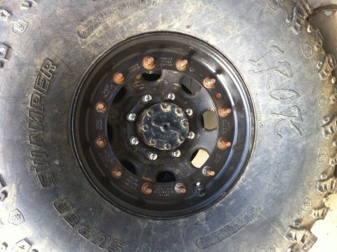 1996 Ford Bronco - A close-up view of a tire and wheel assembly, showing the tread and rim details.