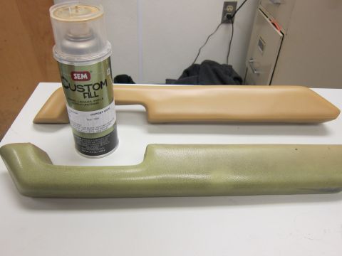 1987 Dodge 1500 - Two door armrests, one light tan and one olive green, sit next to a can of SEM Custom Fill spray paint labeled 'Dupont Vinyl' and 'Year: 19…