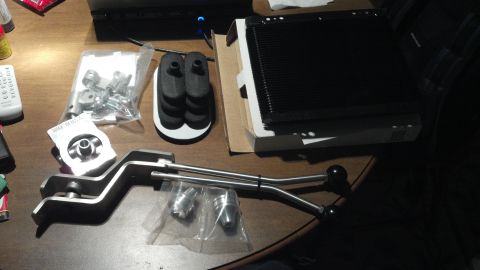 1979 Ford Bronco - Various transmission and engine parts are laid out on a table, suggesting a repair or upgrade.