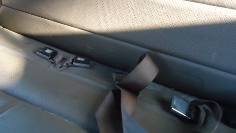 1996 Ford Bronco - The interior of a vehicle shows perforated upholstery and seatbelts. The registry claims this is a 1996 Ford Bronco.