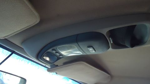 1996 Ford Bronco - The interior overhead console of a vehicle, a light and storage compartment.
