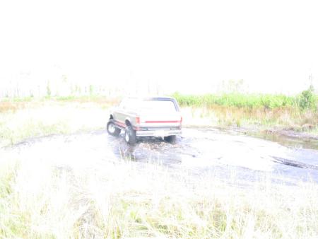 1991 Ford Bronco - This 1991 Ford Bronco is navigating a wet, muddy terrain.