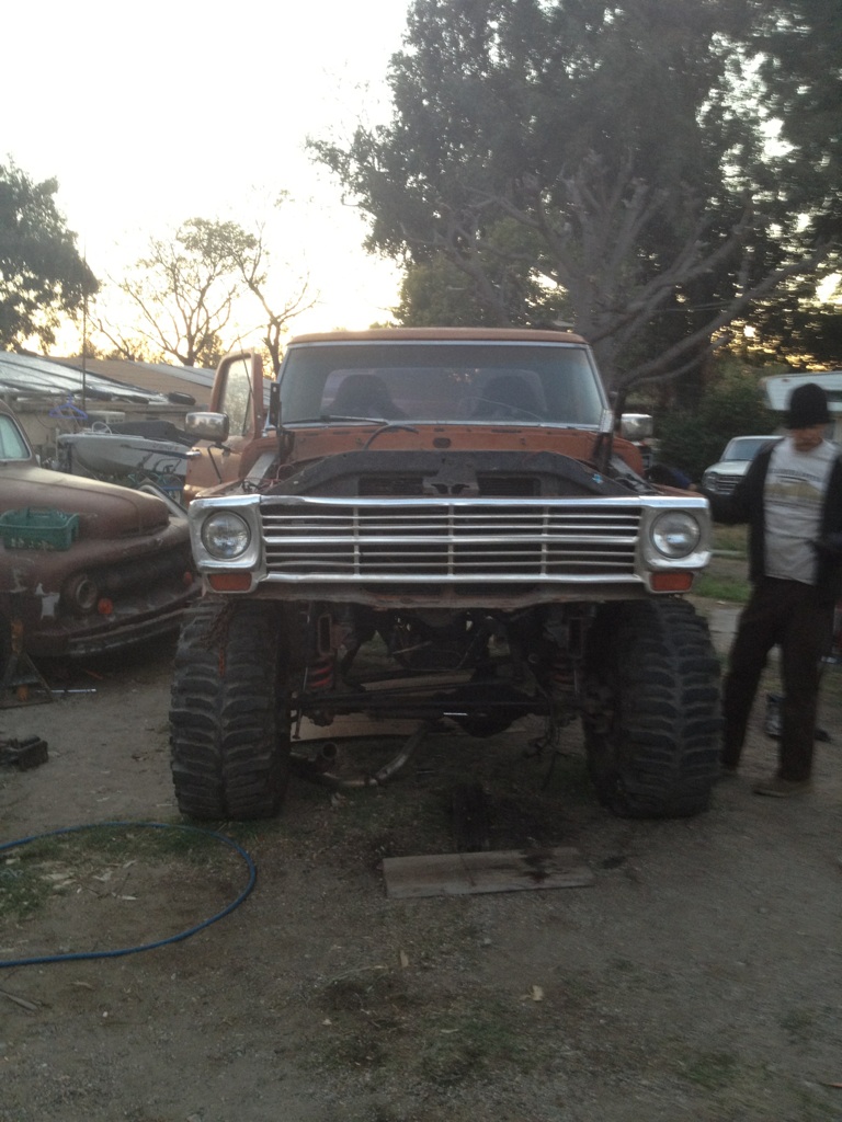 1969 Ford F-250 front view with large tires and hood open