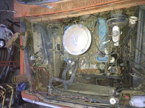 1969 Ford F-250 - Engine bay of a vehicle, likely a truck, with a V8 engine and various components visible.